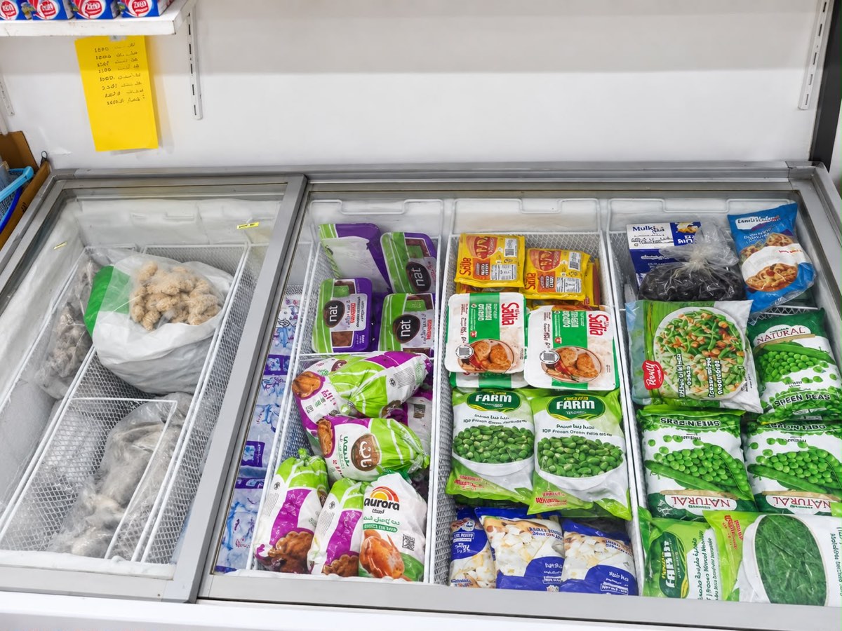 Chest freezer holding frozen vegetables and poultry